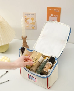 Detail of corduroy makeup bag with large capacity storage for cosmetics on a vanity