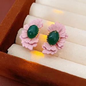Vintage floral earrings with pink petals and green gemstones in a premium velvet box