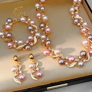 Vintage style jewelry set with pearls and rhinestones in an elegant golden gift box