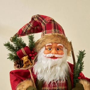 Handcrafted Santa Claus figurine in red plaid suit with bear and pine branch ornament