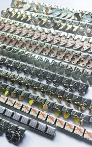 Detailed grid of stainless steel modular charm links with colorful enamel and shells