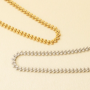 Detailed macro view of adjustable wheat leaf chain necklace in gold and silver finish