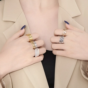 Detail shot of Roman numeral rings in gold, silver, and rose gold with zircon stones