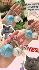 Detailed view of mini baseball keychain featuring leather glove, wood bat and white ball