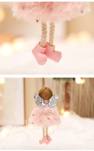Detail of pink Christmas angel plush ornament with silver wings and star sequins