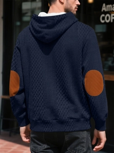 Détail du sweat à capuche bleu marine avec texture en losanges et empiècements aux coudes