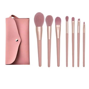 Detailed set of 7 pink makeup brushes with rose gold ferrules and a PU leather storage bag