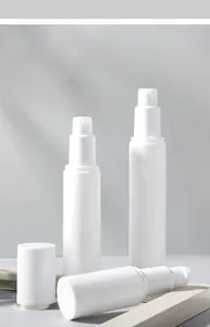 Minimalist white plastic lotion pump bottles on a wooden stand with natural tree shadows