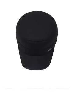 Detail shot of black wool flat top winter cap with side metal logo and twill texture