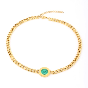 Close-up of golden Cuban chain necklace with round green malachite stone pendant