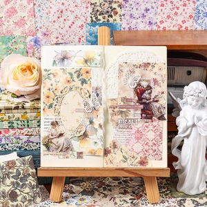 Vintage floral scrapbooking material set with decorative papers and stickers on a wooden stand