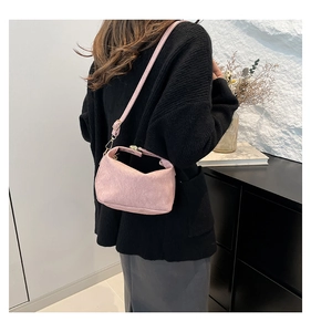 Pink strawberry pattern shoulder bag shown on model with elegant minimalist background