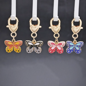 Set of four colorful enamel butterfly keychains with gold heart-shaped lobster clasps