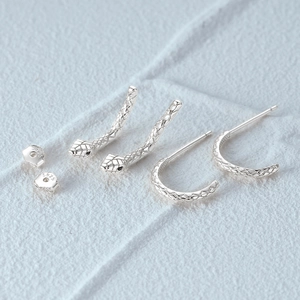 Macro shot of S925 sterling silver snake earrings with scale textures and S925 hallmark