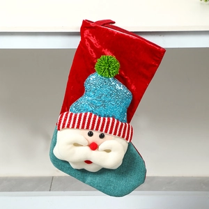 Detail of red velvet Christmas stocking with 3D Santa Claus and sequin hat decoration