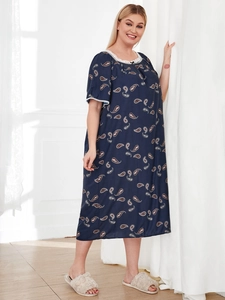 Detail view of navy blue paisley nightdress with white lace trim and short sleeves