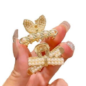 Elegant gold metal hair claw set with white pearls in butterfly and bow designs