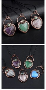 Macro detail of vintage heart pendants with natural stones and abalone shell insets