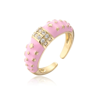 Detail of pink enamel ring with golden star relief and sparkling zircon inlay