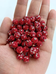 Detailed macro of a 10mm red clay Shamballa bead with sparkling rhinestones for jewelry