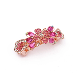 Detail of rose gold spring hair clip with pink rhinestones and floral gem patterns