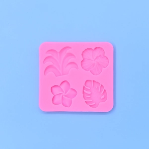 Pink silicone mold featuring tropical hibiscus, frangipani and monstera leaf shapes