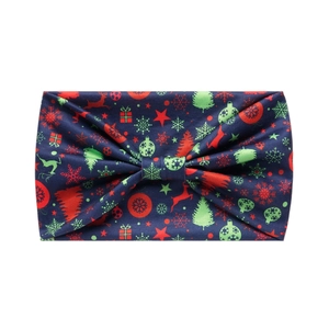 Detailed view of dark blue Christmas headband with festive reindeer and tree patterns