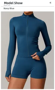 Detail of navy blue slim fit yoga jacket with thumbholes and matching sports shorts