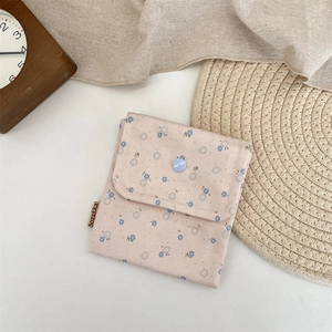 Detail of floral cotton organizer pouch with blue snap button and vintage decor