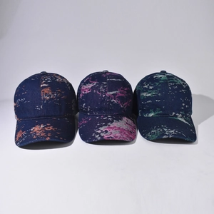 Three denim baseball caps with abstract jacquard patterns in blue, orange and green