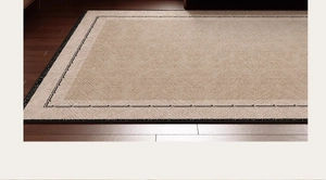 Detailed view of vintage French rug with herringbone texture and black geometric border