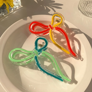 Detail of jelly-colored bow hair claws with transparent finish and metal spring