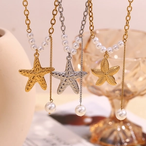 Detailed close-up of 18K gold and silver starfish pendant necklaces with pearl tassels