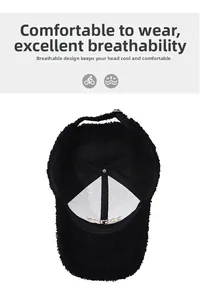 Detail of black teddy fleece baseball cap showing inner sweatband and metal lettering