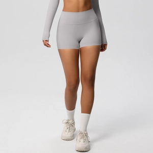 Slim fit high-waisted yoga shorts in light grey styled with a long-sleeve athletic top