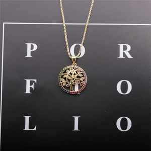 Detailed close-up of golden Tree of Life pendant with colorful zircon on box chain necklace