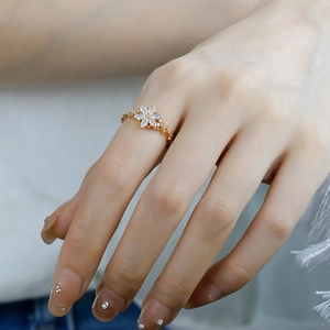 Macro shot of 14K gold plated S925 silver ring featuring a white opal flower design