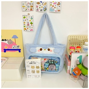 Detail of light blue plush ita bag with transparent PVC layer and cute cat ears