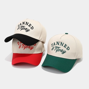 Three multi-color cotton baseball caps with TANNED & Tipsy embroidery on white background