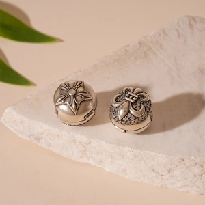 Detailed view of vintage silver iris flower and star earrings with zircon inlay