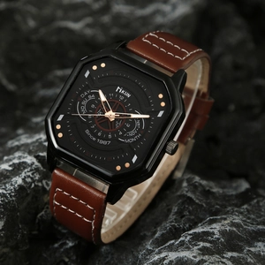 Macro shot of a men's square quartz watch with a brown leather strap on dark rock surface