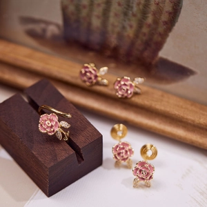Macro view of pink rose ring and earrings set with micro-inlaid zircons and enamel