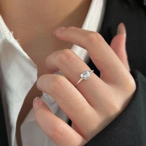Close-up of minimalist 925 silver ring featuring a sparkling heart-shaped zircon stone