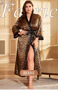 Detail of leopard print satin robe fabric with elegant black piping and belt