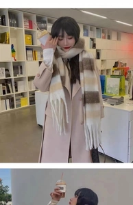 Close-up of a soft brown and beige striped scarf with fringe detail worn in a cozy bookstore