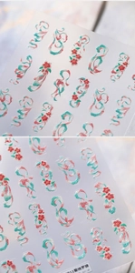Macro shot of 3D embossed nail stickers featuring delicate cherry blossoms and silk ribbons