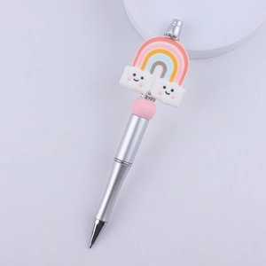 Close-up of DIY beadable pen with cartoon rainbow cloud topper and rhinestone spacer