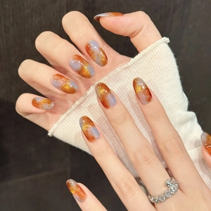 Orange and grey marble nail art with gold glitter on long oval handmade press-on nails