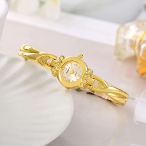 Elegant gold metal bracelet watch for women featuring a stylish twisted bangle design