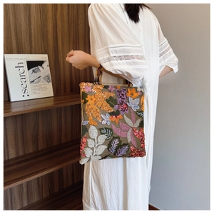 Linen tote bag with vibrant sequin floral embroidery and elegant tortoiseshell handles